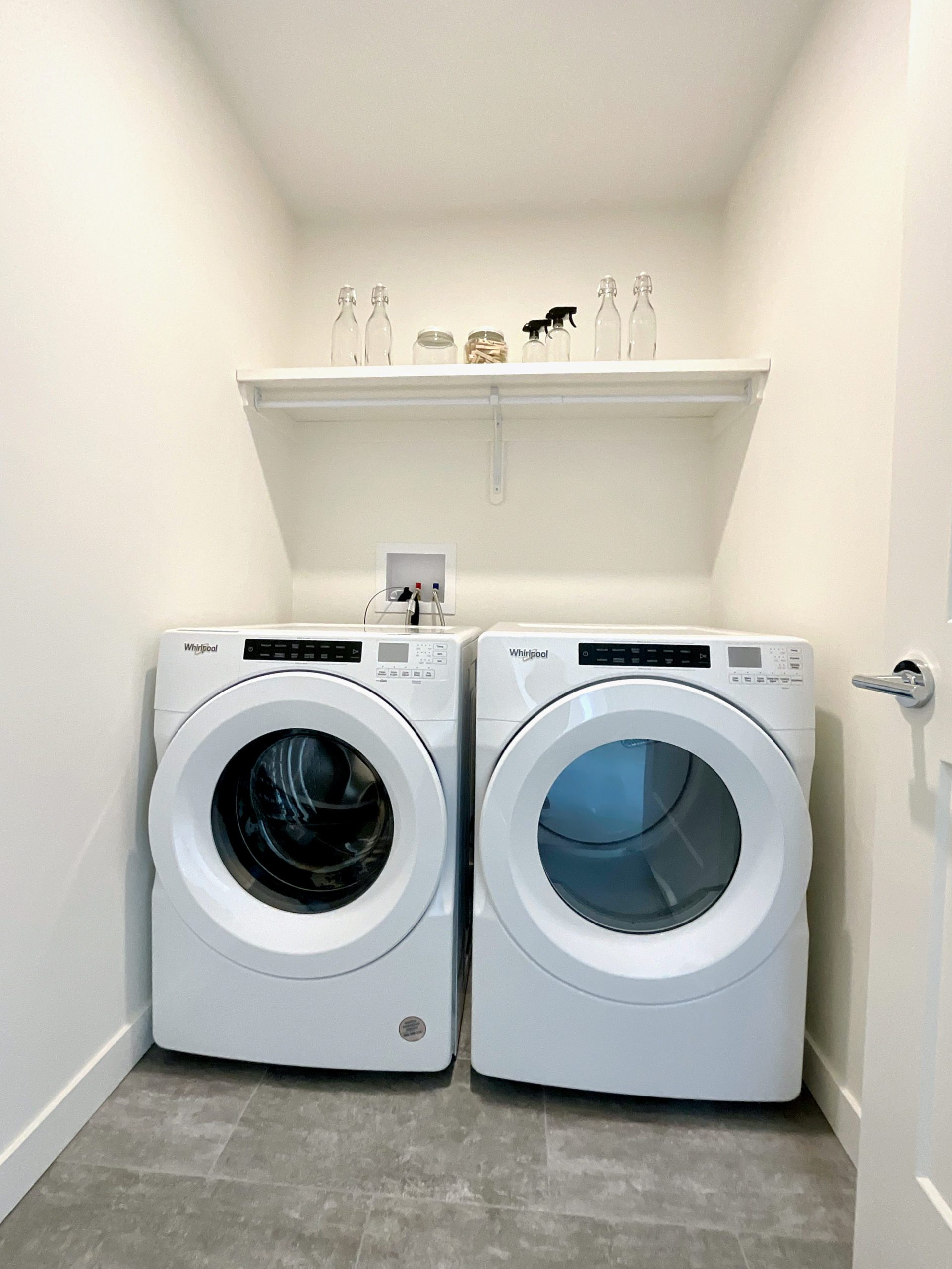 A laundry room with side-by-side front load washer and dryer.