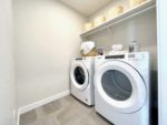 Upstairs laundry room with side-by-side front load washer and dryer.