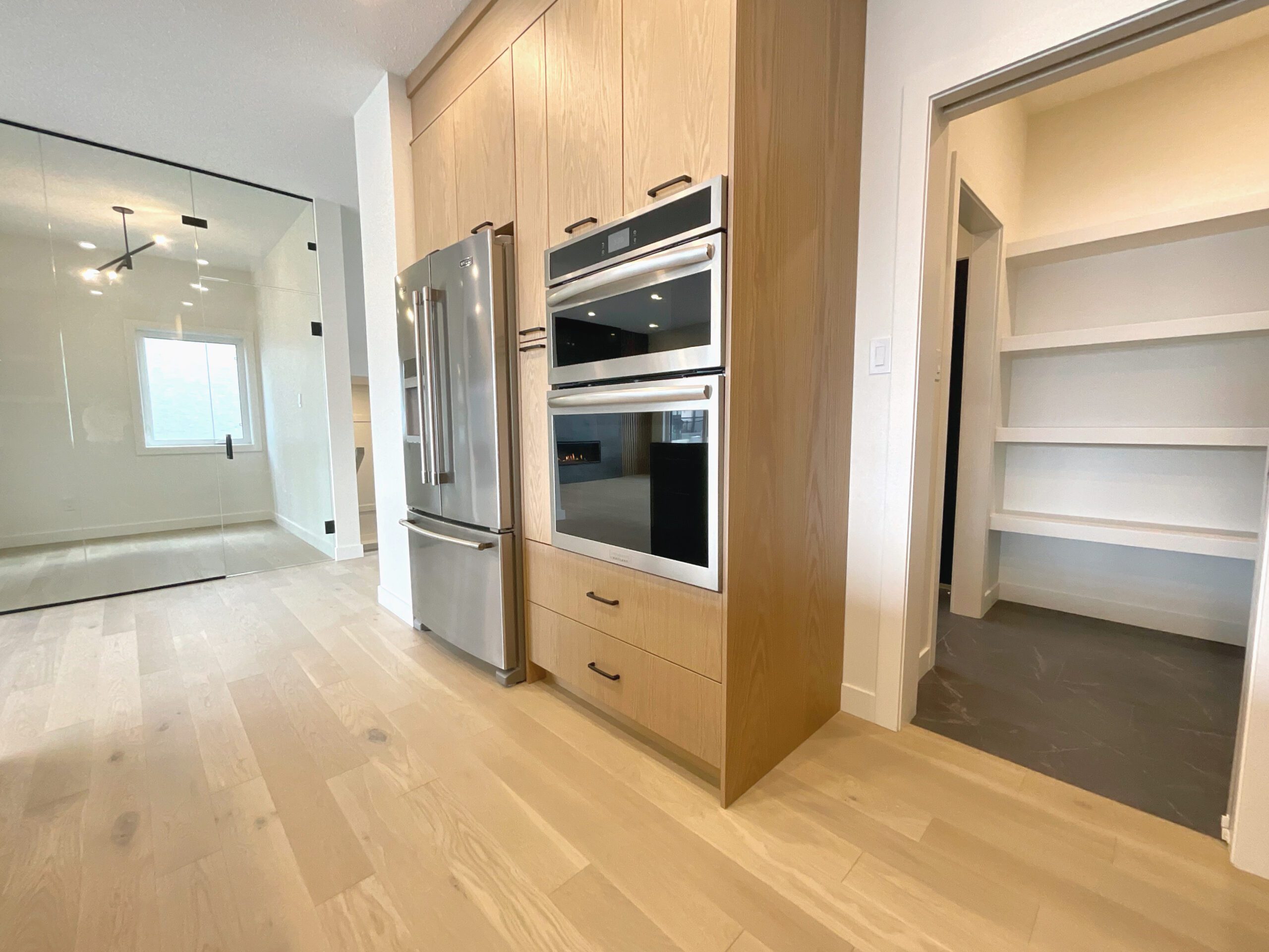 A kitchen with a built-in stove and a refrigerator.