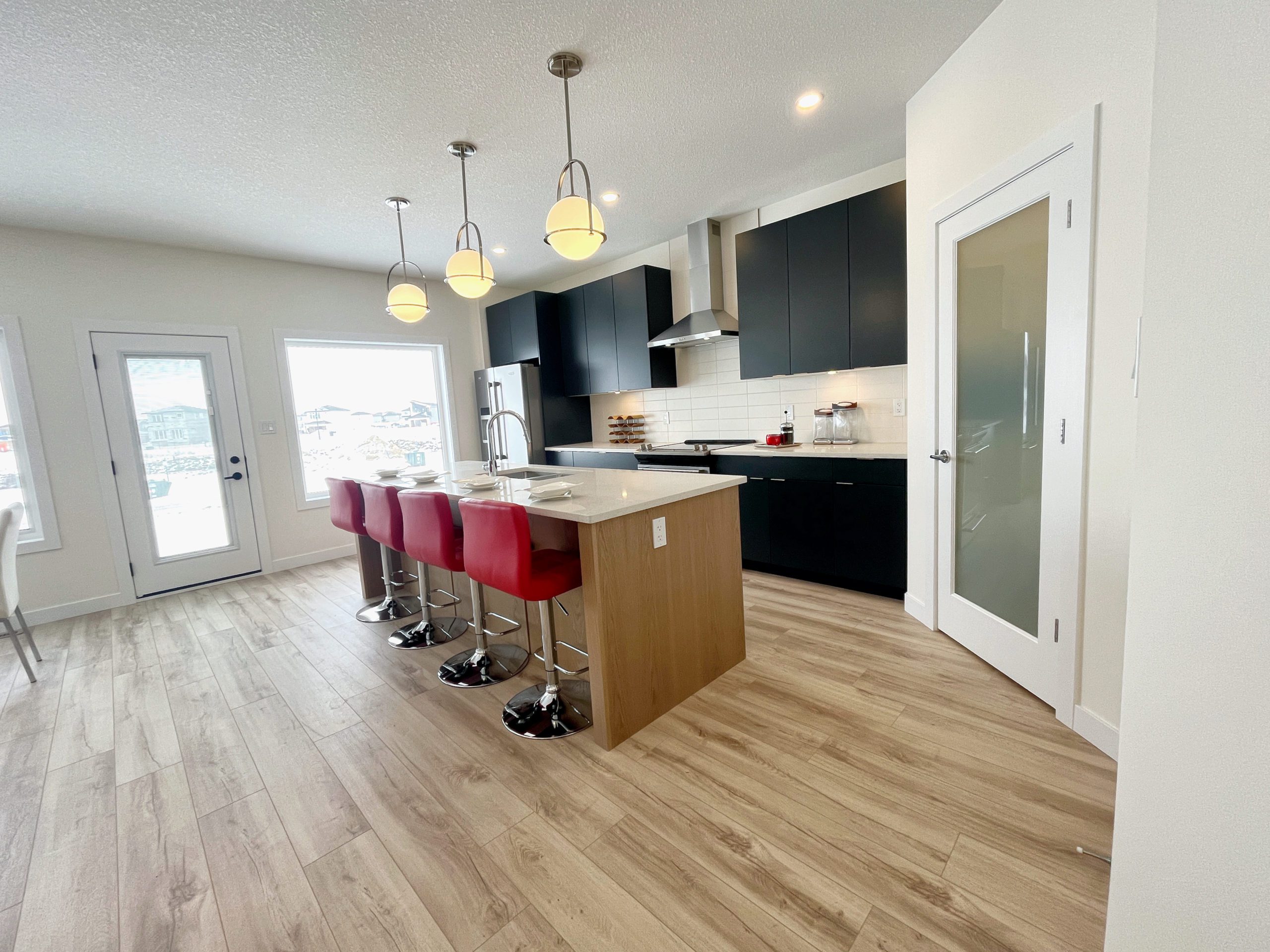 Shows the kitchen island and four counter height stools.