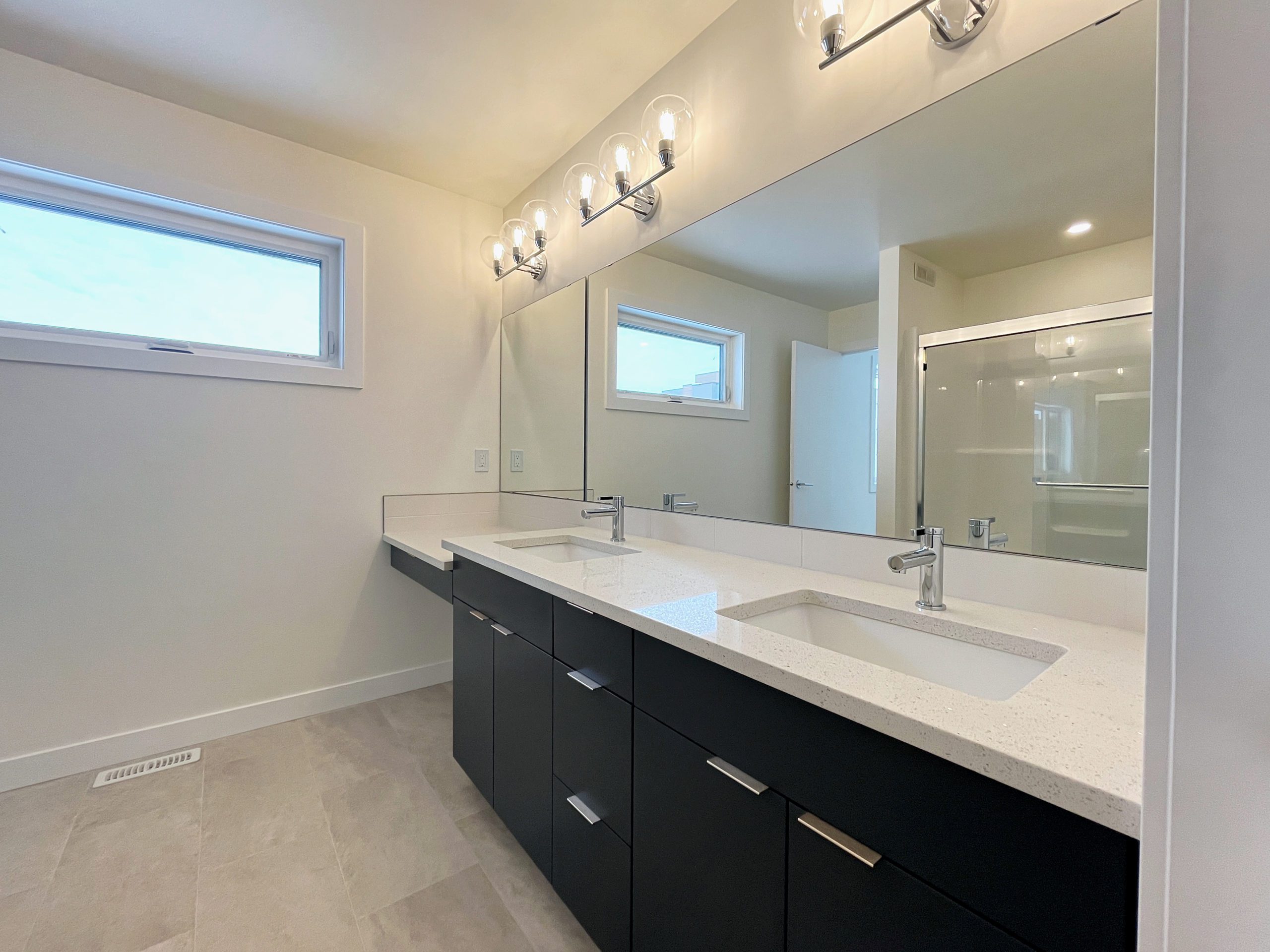 Double-sink and makeup counter in the ensuite bathroom.