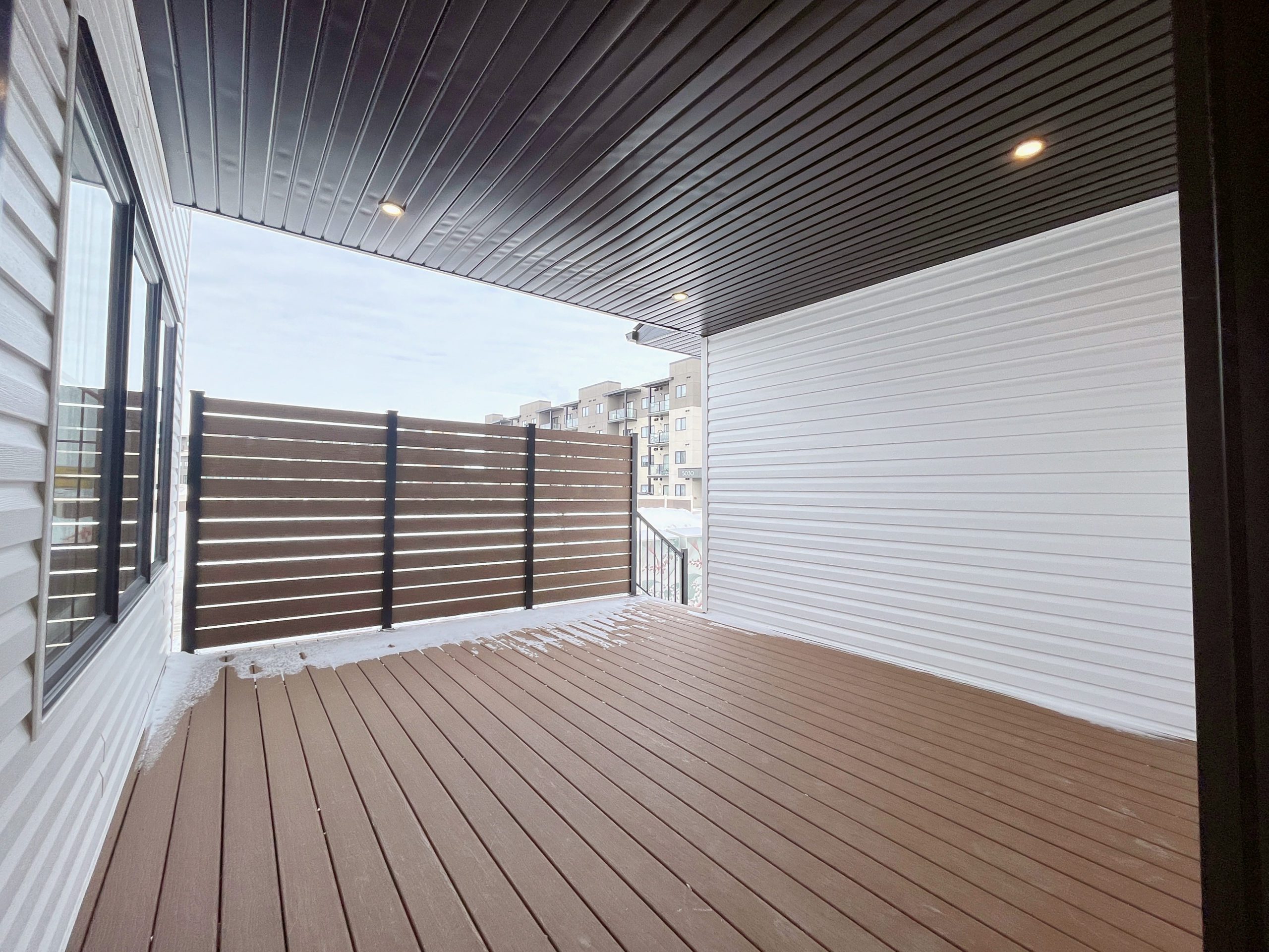 The exterior covered composite deck with privacy wall.