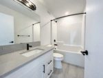 Family bathroom with a toilet, sink, and combination shower bathtub.