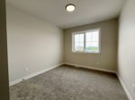 Shows an empty bedroom with a window.