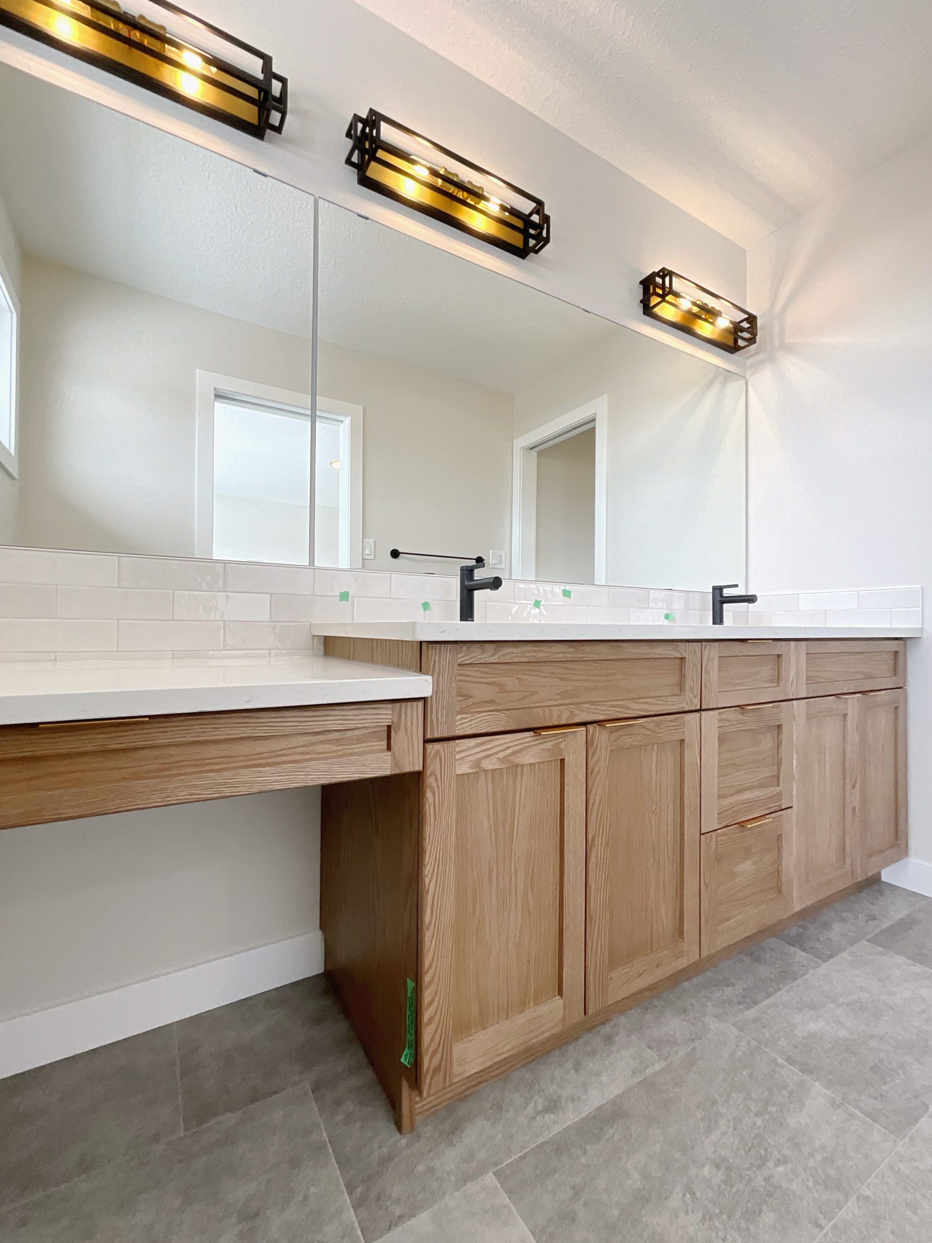 Shows the Primary ensuite bathroom with two sinks and a large mirror.