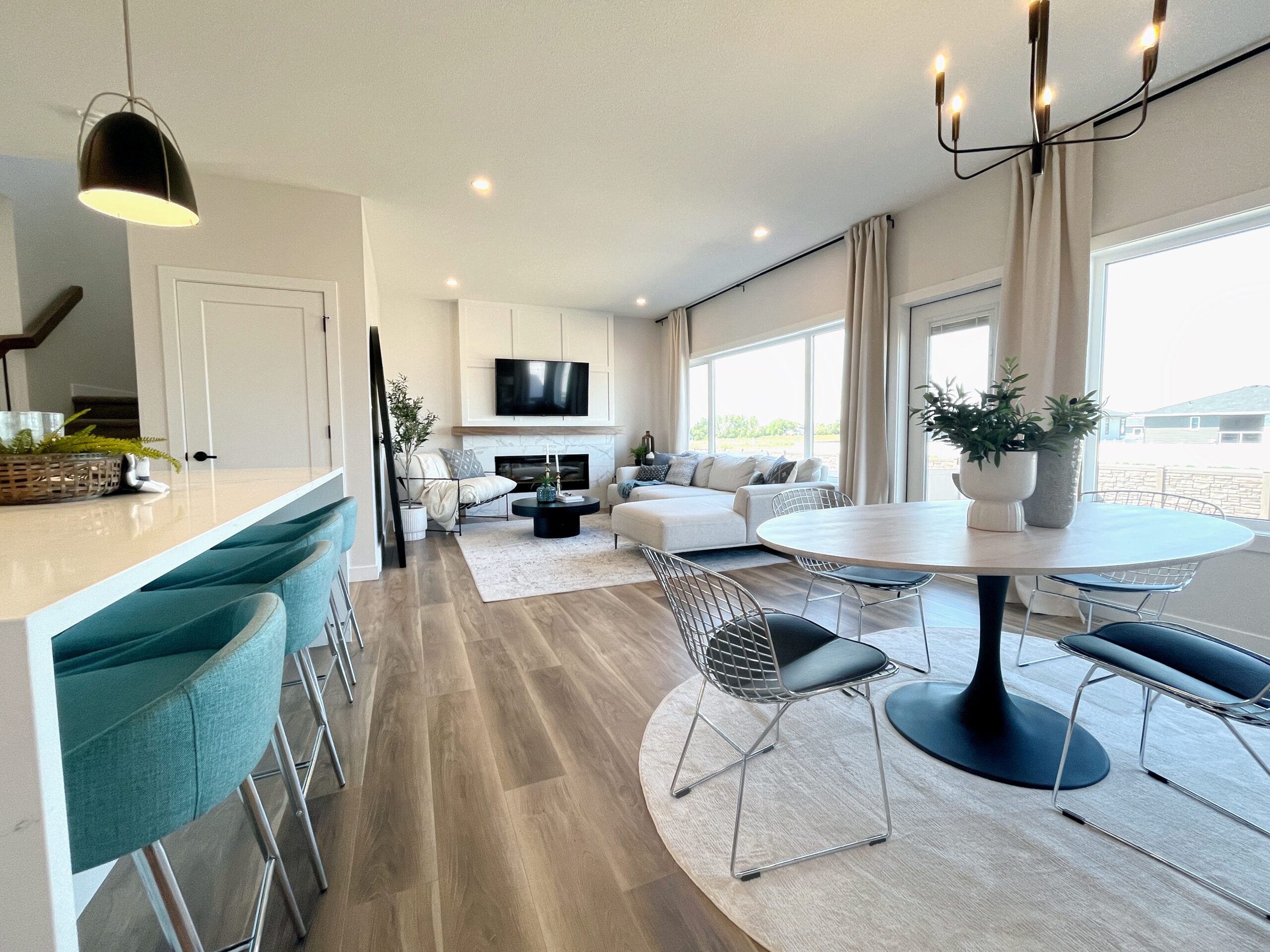 A living room and dining room in a modern two-storey home in Pilot Butte.