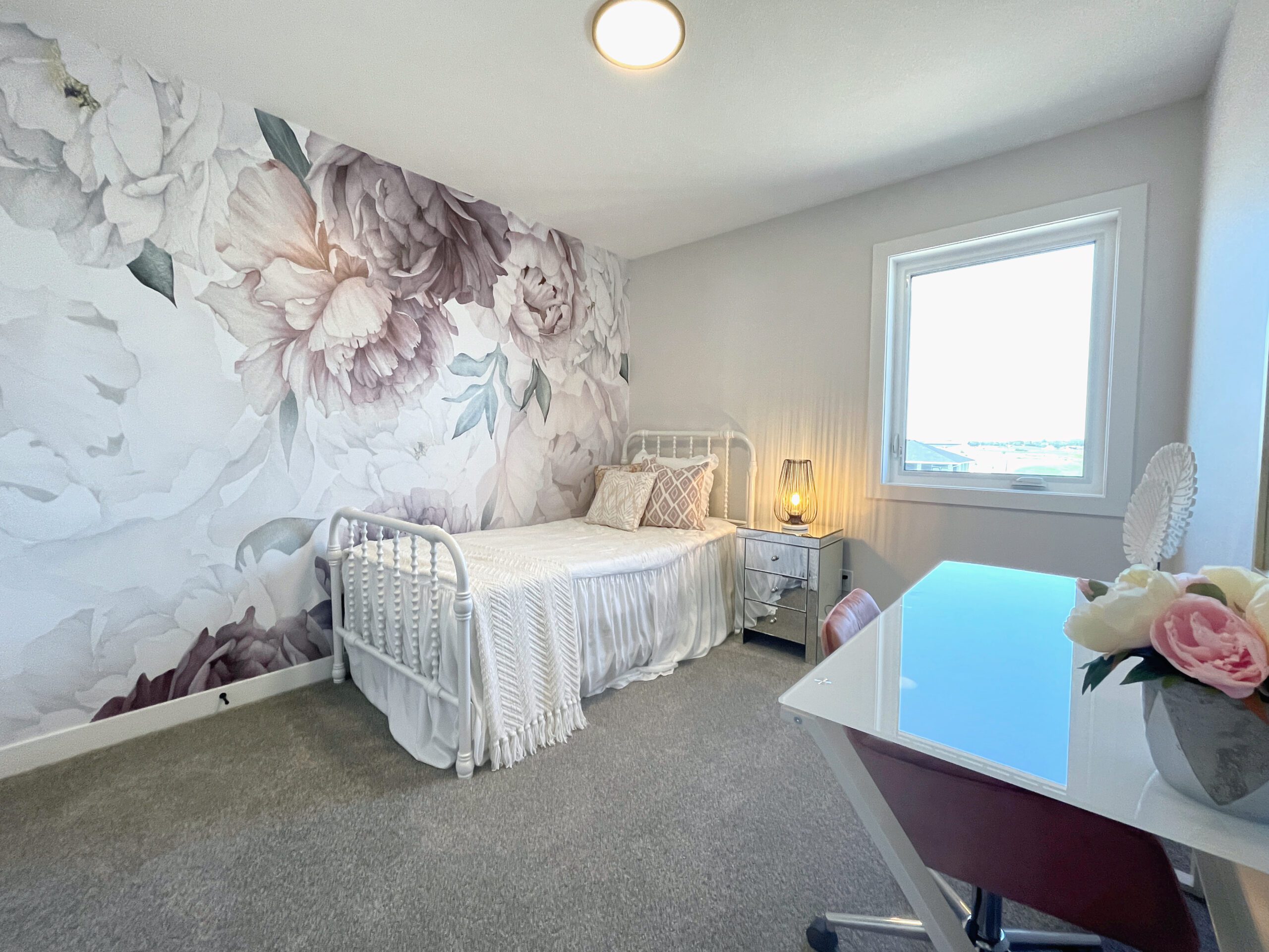 A two-storey home in Pilot Butte with a bed and a desk.