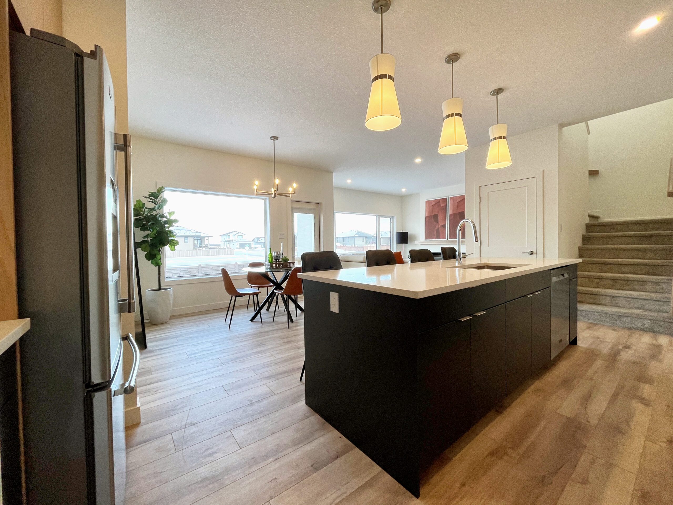 A spacious kitchen and dining area in a two-storey home in Pilot Butte.