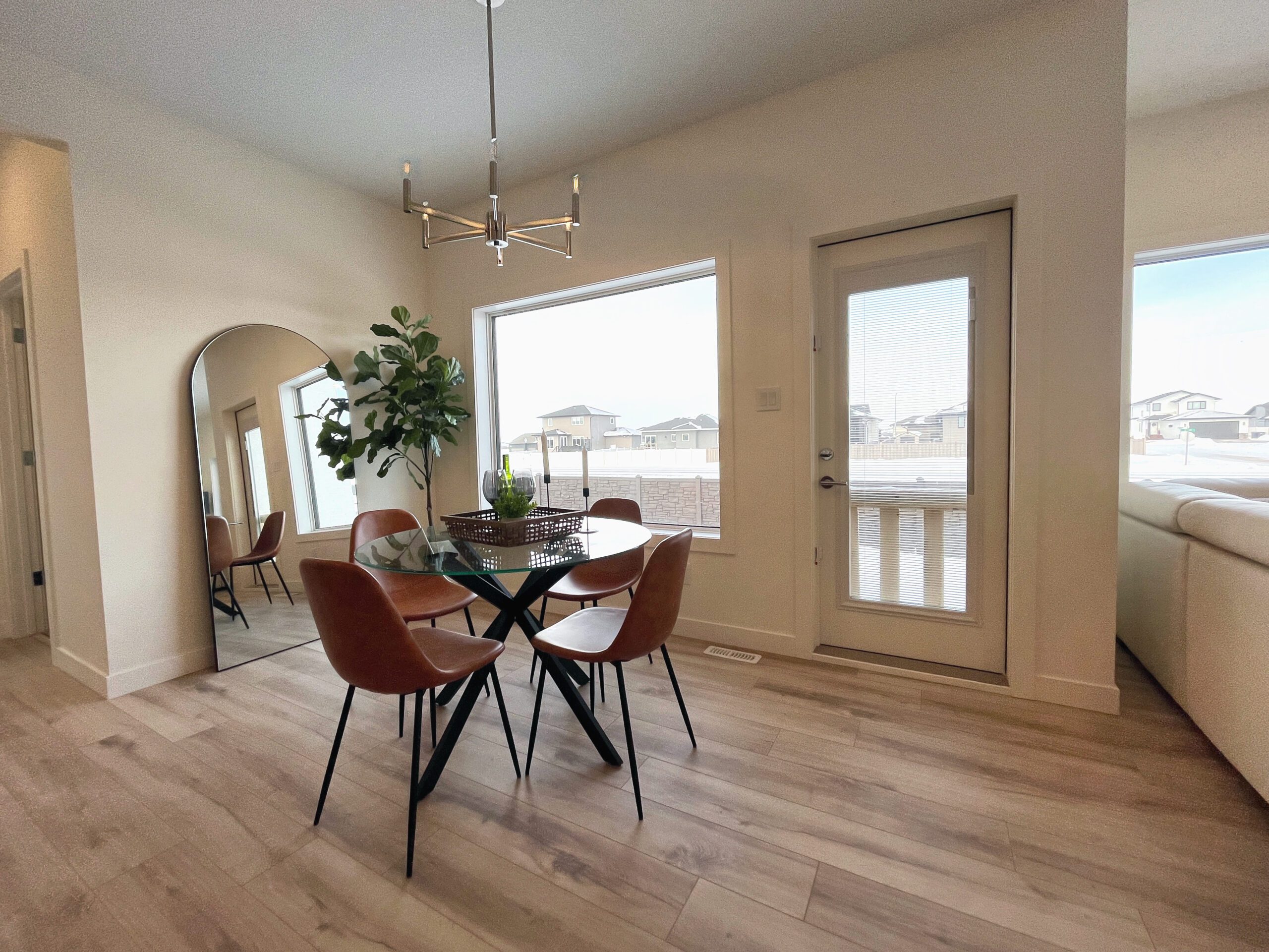 A dining table and chairs in a two-storey home in Pilot Butte.
