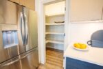 A kitchen with a stainless steel refrigerator.