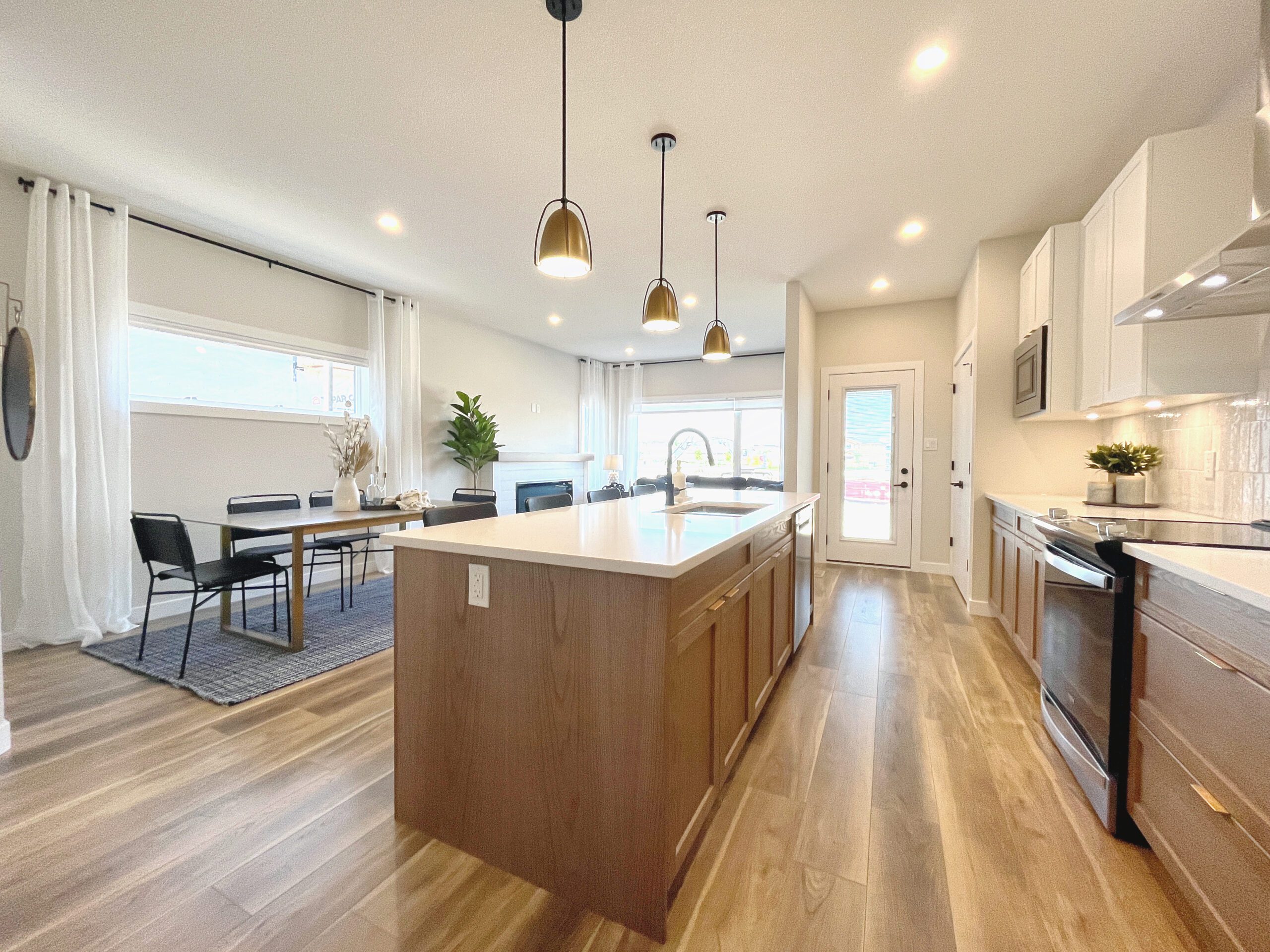 A kitchen with hardwood floors and a large island.