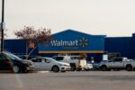 Walmart Supercentre exterior with a parking lot and several cars.